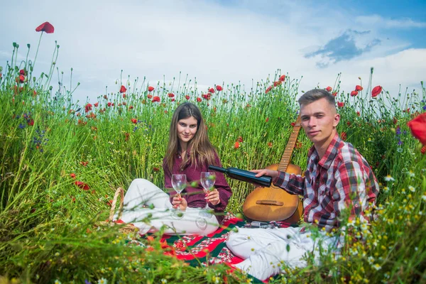 love and romance. opium. spring countryside. lovers with guitar in flower field. music.