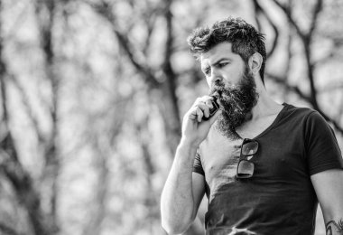 Uzun sakallı adam sigara içmekten rahatlamış. Sakallı ve bıyıklı adam duman üflüyor. Stres atma konsepti. Tüttüren sakallı adam. Beyaz aromalı duman bulutları. Elektronik sigara içiyorum.