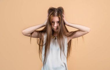 Üzgün genç kız saçlarına dokunuyor. Başı ağrıyan çocuk. migren.