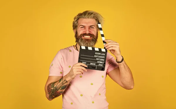 Bearded man hold movie clapper. Film making concept. Clapperboard copy space. Watch movie. Film director. Actor casting. Shooting scene. Favorite series. Action. Cinema production. Creative producer