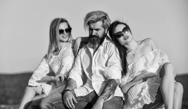 Yaz tatili. İlişkiler dostluk romantizmi. Üçlü aşıklar. Serbest ilişki. Üçlü konsept. İkisine de aşığım. Çatı partisi. Havalı hipster ve kadın beyaz elbiseler. Kadınlar ve erkekler sarılıyor.