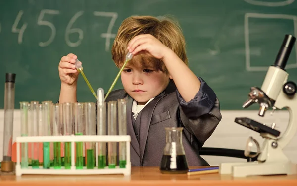 small boy at science camp. microscope at lab. Scientific experiment. Pupil looking through microscope. student do science experiment with microscope in lab. small boy use microscope at school lesson