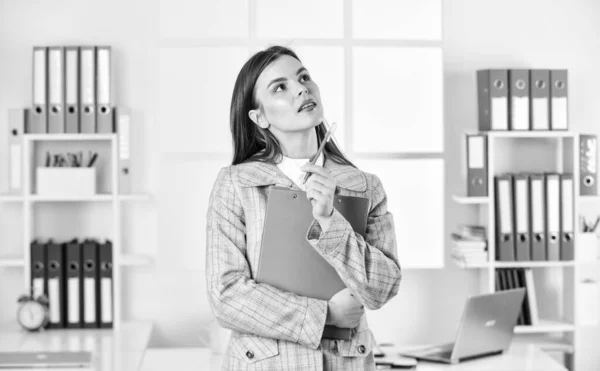 elegant woman with document folder. thinking office worker. formal fashion style. stylish woman work at workplace. girl follow dress code. confident businesswoman with laptop