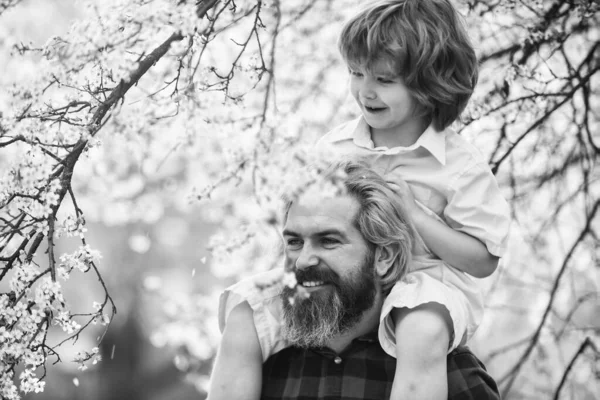 Best dad ever. Child having fun with dad. Happy family. Little boy and father in nature background. Springtime. Hipster piggybacking baby. Bearded brutal man good father. Fathers day. Dad and son