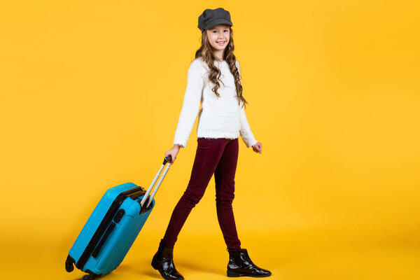 on the way. ready for vacation trip. adventure. happy teen girl with bag. spring kid fashion style.