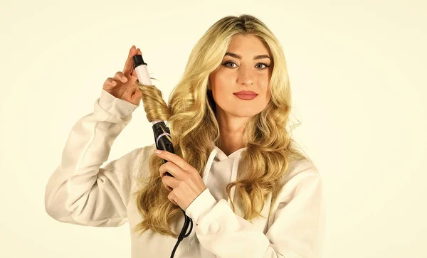 Ceramic coating that minimizes harm. Woman with long curly hair use curling iron. Hairdresser equipment. Heat setting for hair type. Girl adorable blonde hold curling iron white background