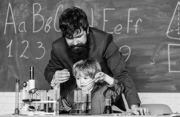 School knowledge. Teacher bearded man and boy chemical laboratory. Happy teachers day. Knowledge day. Basic level chemistry knowledge. Study chemistry and biology. Congratulations September 1 holiday
