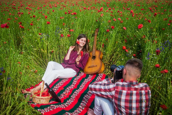 romantic couple among poppies. love and romance. opium. spring countryside.