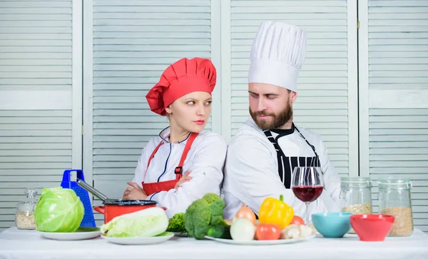 Reasons why couples cooking together. Cooking with your spouse can strengthen relationships. Ultimate cooking challenge. Couple compete in culinary arts. Woman and bearded man culinary partners