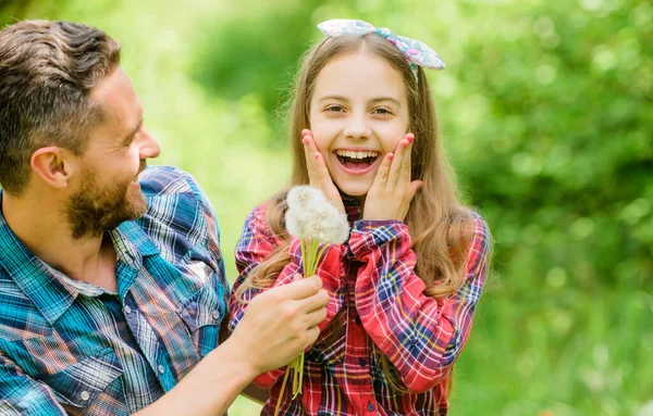 Denken wir an die Ökologie. kleines Mädchen und glücklicher Mann Papa. Tag der Erde. Frühlingsdorf. Familienferienhof. Ökologie. Glücklicher Familientag. Tochter und Vater lieben Löwenzahnblume — Stockfoto