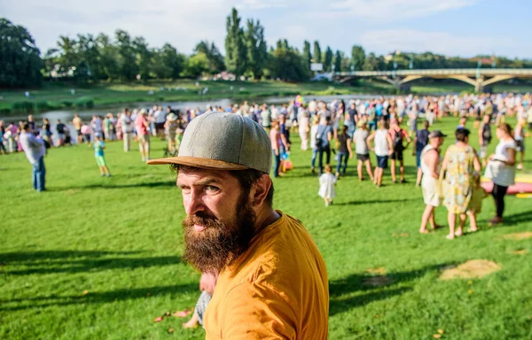 This man is a real hipster. Bearded man on summer landscape. Man with mustache and beard hair on unshaven face. Brutal man in casual wear relaxing outdoor — Stock Photo, Image