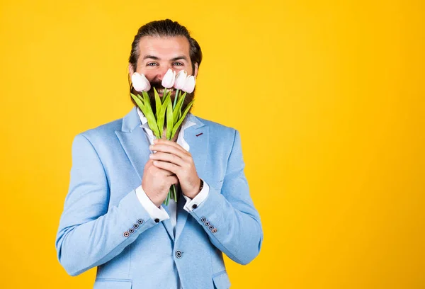 man holding bouquet of tulips. happy valentines day. man share tulip flowers. natural present for her. celebrate the holiday. man with beautiful spring flowers. Fresh tulips bouquet. Feeling playful