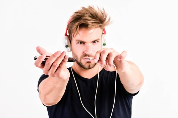 Music conneting people. unshaven man listening music in headset. sexy muscular man listen sport music. man in earphones isolated on white — Stock Photo, Image