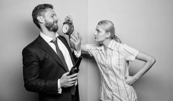 Man alcoholic drink wine. woman show time on alarm clock. wife wondering why husband came so late. family couple routine. problems in relationship. family psychology. unhappy life — Stock Photo, Image