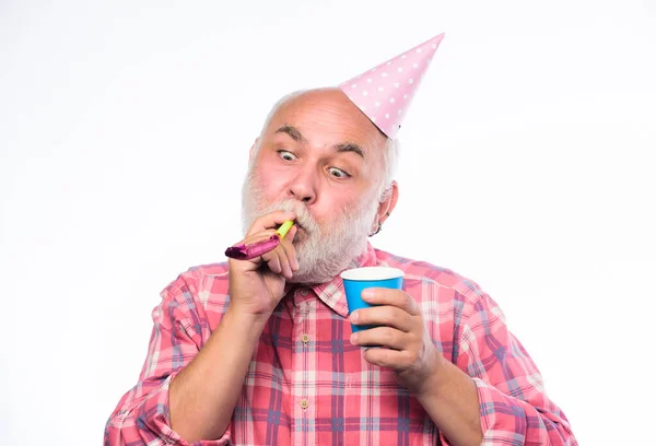 Birthday concept. Ideas for seniors birthday celebrations. Man bearded grandpa with birthday cap and drink cup. Grandfather graybeard blowing party whistle. Getting older is still fun. Elderly people — Stock Photo, Image