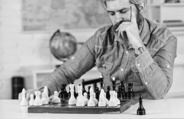 Figures on wooden chess board. Thinking about next step. Chess is gymnasium of mind. Chess lesson. Strategy concept. School teacher. Board game. Smart hipster man playing chess. Intellectual hobby