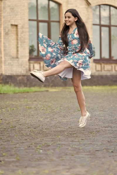 I am free. Happy girl jump up outdoors. Energetic child in suumer dress. Free to move. Summer vacation. Leisure and free time. Playing games. Freedom and happiness. Born free