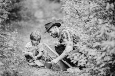 Bahçedeki küçük yardımcı. Çiftlik ailesi. Doğada yaşayan küçük bir çocuk ve baba. Bahçe aletleri. Bahçıvanlık hobisi. Babası küçük oğluna bitkileri yetiştirmeyi öğretiyor. Bahar bahçıvanlığı rutini. Çiçek ekiyorum.