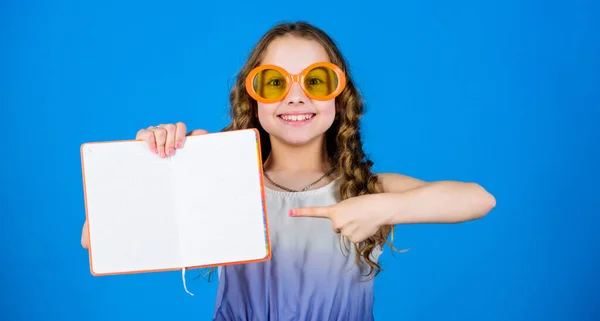 Lesebuch. Sommermode. Tagebuchnotizen. Pläne für Sommerferien und Urlaub schmieden. kleine Schönheit Mädchen schreiben ihre Erinnerungen. kleines glückliches Mädchen mit Brille und Notizbuch. Kopierraum. Verlag — Stockfoto