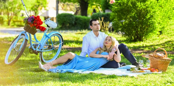 Perfect spring date. Idyllic moment in garden. Man and woman in love. Couple sit blanket. Happy together. Romantic picnic. Picnic time. Long lasting relationship. Couple having picnic in local park