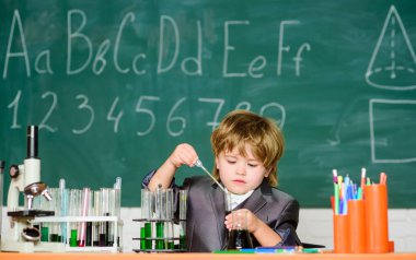 Mikroskop ve test tüpleri sınıfındaki çocuk. Bilgi kavramı. Bilgi toplama günü. Çocuk biyoloji kimyası okuyor. Mutlu bir çocukluk. Temel bilgi ilkokul eğitimi. Eğitim Deneyi