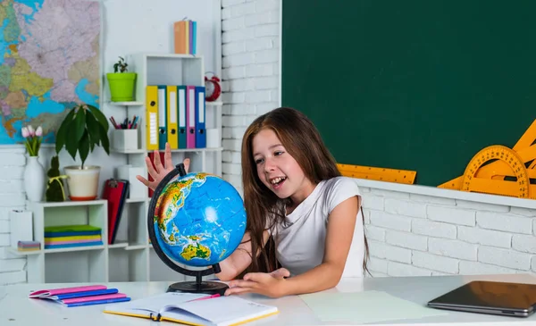 快乐的小女孩在学校和全球一起学习地理，学习 — 图库照片