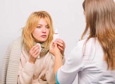 Soğuk algınlığının semptomlarını fark et. İlaçlar soğuğu hızlı yenmeye yardımcı olmalı. Soğuk algınlığından nasıl kurtulacağına dair ipuçları. Kadın doktorla görüşüyor. Doktor tedavi önerirken fularlı kız mendil tutuyor. Soğuk algınlığı ve grip ilaçları