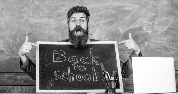 Come to us. Teacher welcomes new pupils enter educational institution. Teacher or school principal welcomes with blackboard inscription back to school. Private school advertising to boost enrollments — Stock Photo, Image
