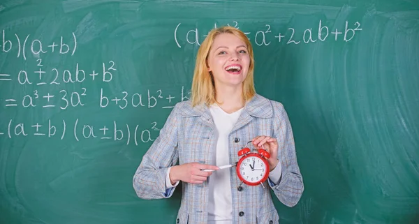 Le importa la disciplina. Es hora de estudiar. Bienvenido año escolar maestro. Buscar profesores comprometidos complementan a los educadores cualificados. Concepto de disciplina escolar. Mujer profesora mantenga el despertador — Foto de Stock