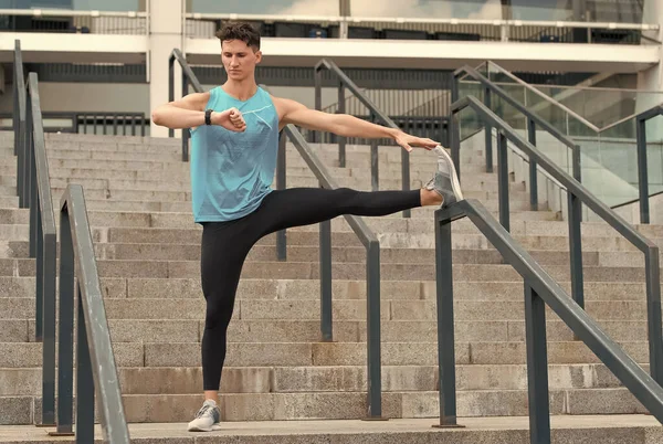 Male runner doing stretching exercise. Exercise of a young man in urban environment. his legs stretched out. achieving the best result. Warm up firstly. healthy life and self-control concept — Stock Photo, Image