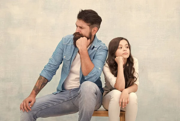 Together is our favorite place to be. Serious daughter and dad sit on stool. Father child relations. Bearded man and small kid with thoughtful look. Family relations. Paternal bonds. Love and care — Stock Photo, Image