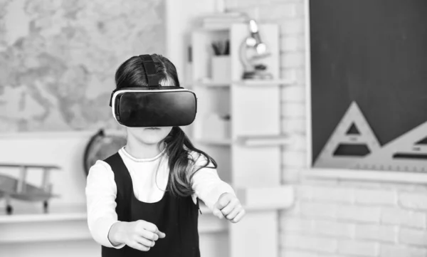 Go around obstacles. Virtual classes. Driving lessons. Science Class. VR technology. schoolgirl using virtual reality helmet. Virtual reality headset. Teenager student girl in classroom. Play game