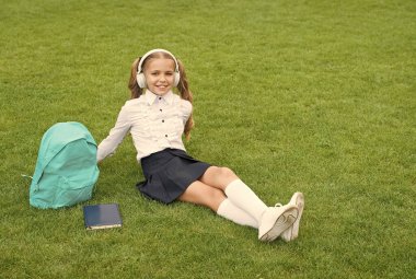 Online öğrenmenin sıradan bir günü. Şirin kız müzik dinler. Okul bahçesinde kitabı olan mutlu anaokulu kızı. Okula dönüyorum. Çalışkan çocuk kulaklık takıyor. Eğitim kavramı