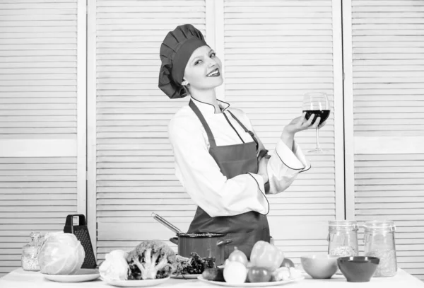 Housekeeping and culinary. Housewife prepare meal with wine. Housewife daily routine. Girl adorable chef. Housewife cooking and drink wine. Enjoy easy ideas for dinner. Woman enjoy cooking food