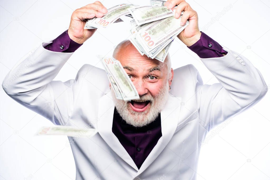 Billionaire. successful businessman. rich mature man has lots of money. business success. Richness. retirement. Happy lottery winner. mature bearded man with dollar banknotes