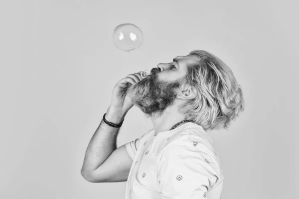 Infantility concept. Carefree man soap bubbles. Summer vacation. Happy playful bearded hipster and soap bubbles. Happiness and joy. Good vibes. Blow inflate bubbles. Forever young guy. Positive — Stock Photo, Image