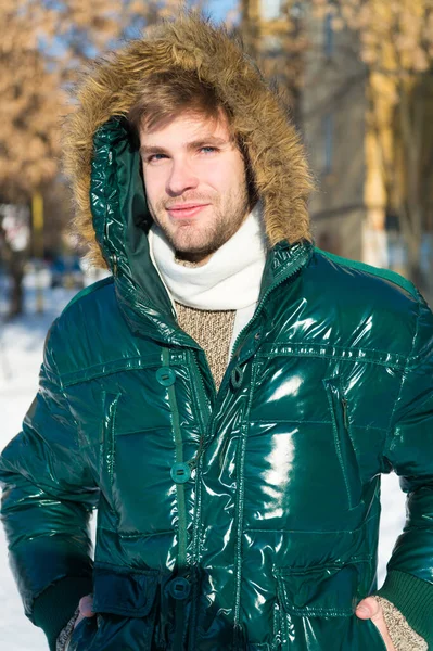 Prepared for weather changes. Winter stylish menswear. Winter outfit. Man unshaven wear warm jacket with fur snowy nature background. Guy wear winter jacket with furry hood. Hipster winter fashion — Stock Photo, Image