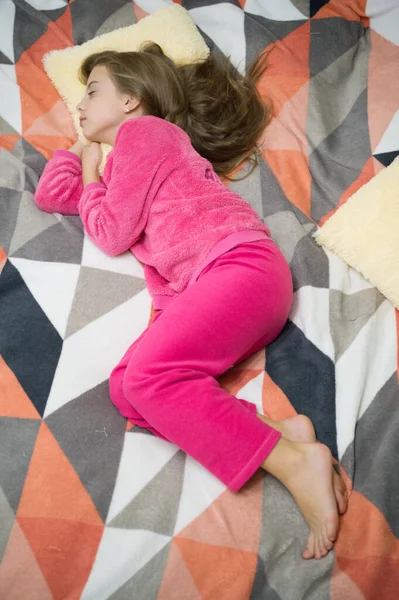 Comfortable pajamas for relax. Girl little kid wear soft cute pajamas while relaxing on bed. Tired baby relaxing. Pajamas and clothes for home. Pajamas and bedroom textile. Child enjoy leisure — Stock Photo, Image