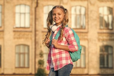 Bahar tatili yeni başladı. En sevdiği şarkı listesi. Çocuk, müzik dinle. Gülümseyen çocuk sesli kitap dinliyor. Mutlu liseli kız kulaklık takıyor. Sırt çantalı küçük bir kız.