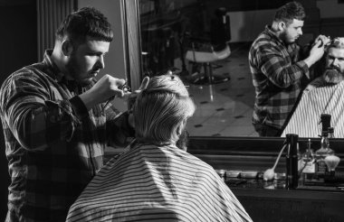 Uzun sarı saçlı adam, dikiz aynasından bakıyor. Saç kes. Berber, sakallı adam için kuaförlük yapıyor. Kendini uyarılmış say. Hipster müşteri saçını kestiriyor. Berber makası