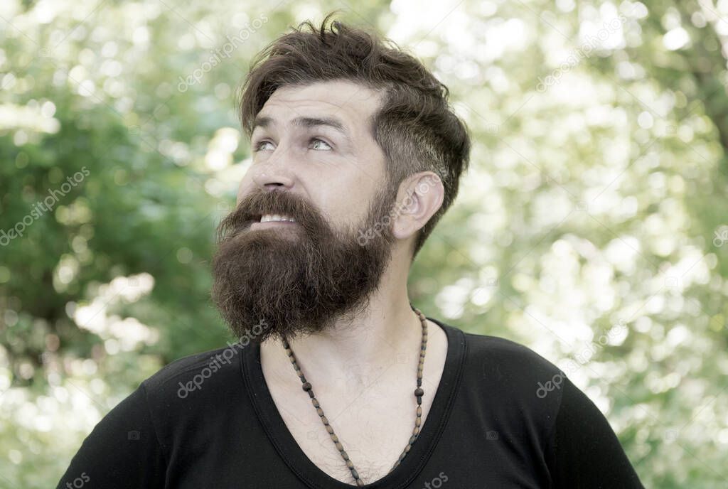 Bearded and beardy. Bearded man on natural environment. Bearded hipster in casual style on summer outdoor. Brutal caucasian guy wearing mustache and beard on bearded face