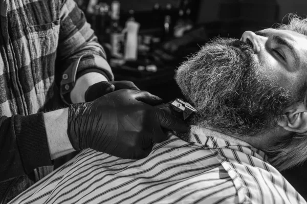 Man shaving. Personal stylist barber. retro and vintage. Designing haircut. barber tools in barbershop. handsome hairdresser cutting hair of male client. Hairstylist serving client at barber shop