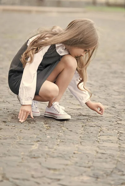 Learning before playing. Little child draw on pavement outdoors. Back to school fashion. Uniform dress. Early childhood education. Playschool and afterschool. Educational games. Playing time — Stock Photo, Image