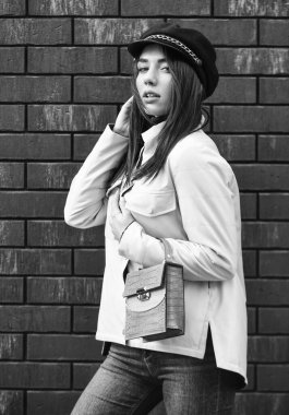 Pembe ceketli, şık bir kadın. modaya uygun şapka başlığı giyiyor. Sokak tarzı. Bahar sonbahar trendi. Pembe ceketli şık bir kadın. Soğuk mevsim. Sonbahar ya da bahar görünümü