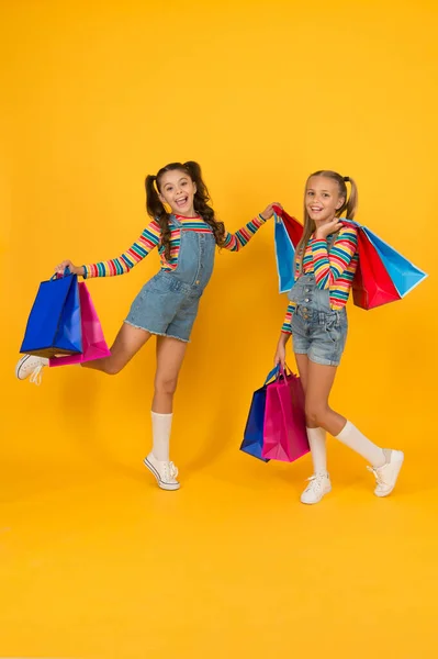 Summer shopping. Buyer consumer concept. Total sale. Kids fashion. Holiday purchase saving. Home shopping. Small girls with shopping bags. Sales and discounts. Happy children. Little girls with gifts