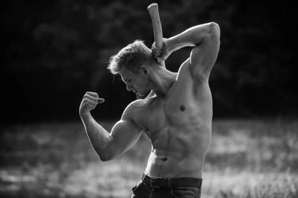 Strength and power concept. Muscular athlete in forest. Sport and fitness. Muscular body. Handsome shirtless man muscular body. Forester with axe. Sexy macho bare torso. Surviving in wild nature — Stock Photo, Image