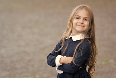 Kendine güvenen bir acemi. Mutlu çocuk dışarıda üniforma giyer. Okula geri dönüş görünüşü. Okul modası. Güzellik bakışı. Erken çocukluk eğitimi. Öğrenci hayatının tadını çıkar, boşluğu kopyala