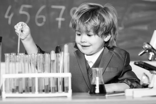 Kleines Kind lernt Chemie im Schullabor. Kleiner Junge im Chemiekabinett. Kind im Laborkittel lernt Chemie Chemielabor. Zurück zur Schule. Experimentieren mit Chemikalien. Wissenschaftler bei der Arbeit — Stockfoto