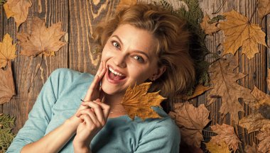 Everyday winner. woman hold maple leaf. canada. girl relax on autumn background. Beauty autumn style. Sharing love to nature. Staying beautiful any season. autumn female fashion. Carefree and happy.