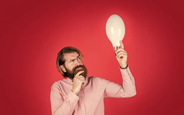 Got new idea. concept of creativity. man just inspired. economy of electricity. bright minded hipster. creative inspiration. light your way. bearded man with bulb. smiling man hold big lamp — Stock Photo, Image